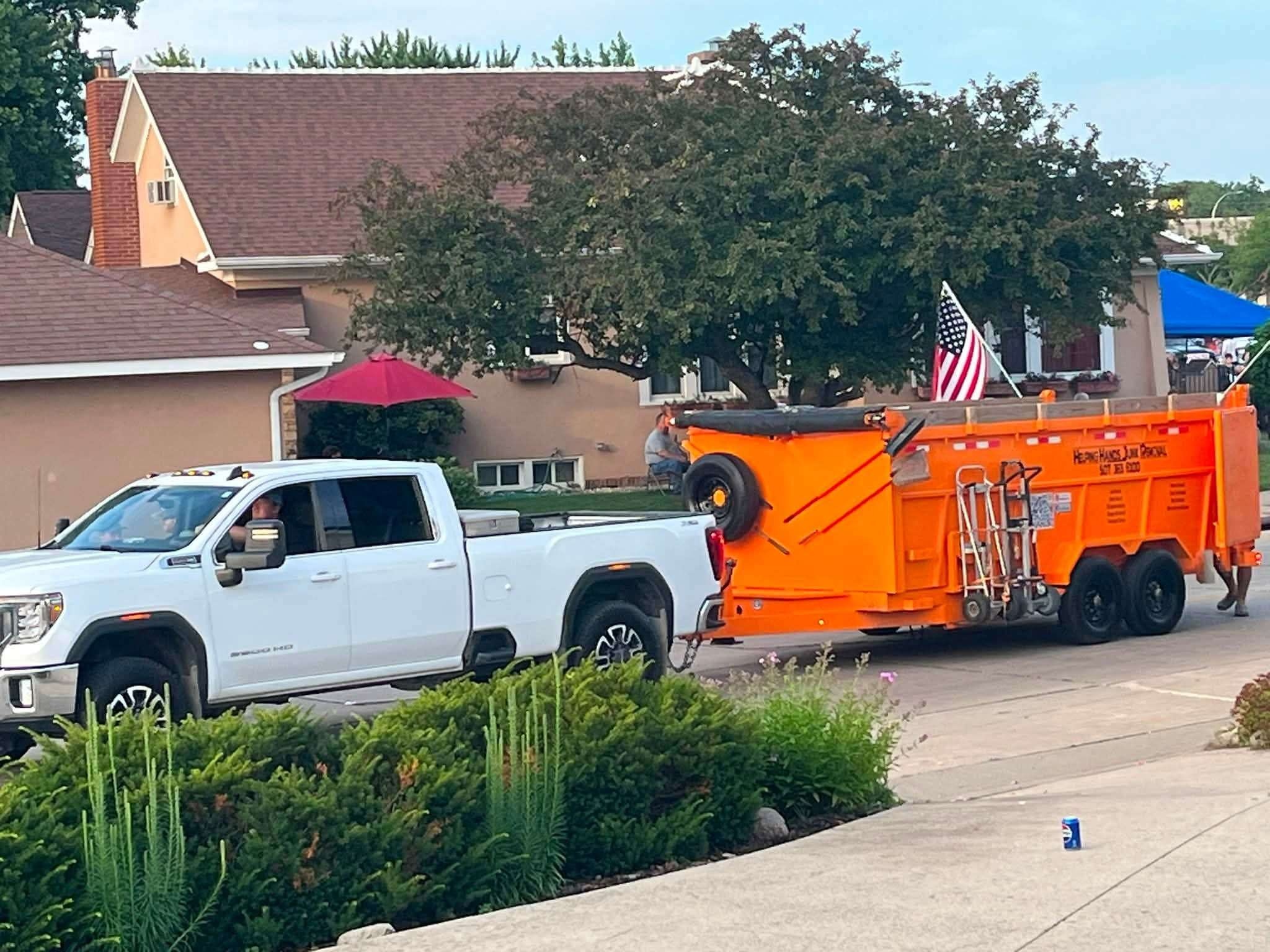 Helping Hands Junk Removal truck and orange trailer