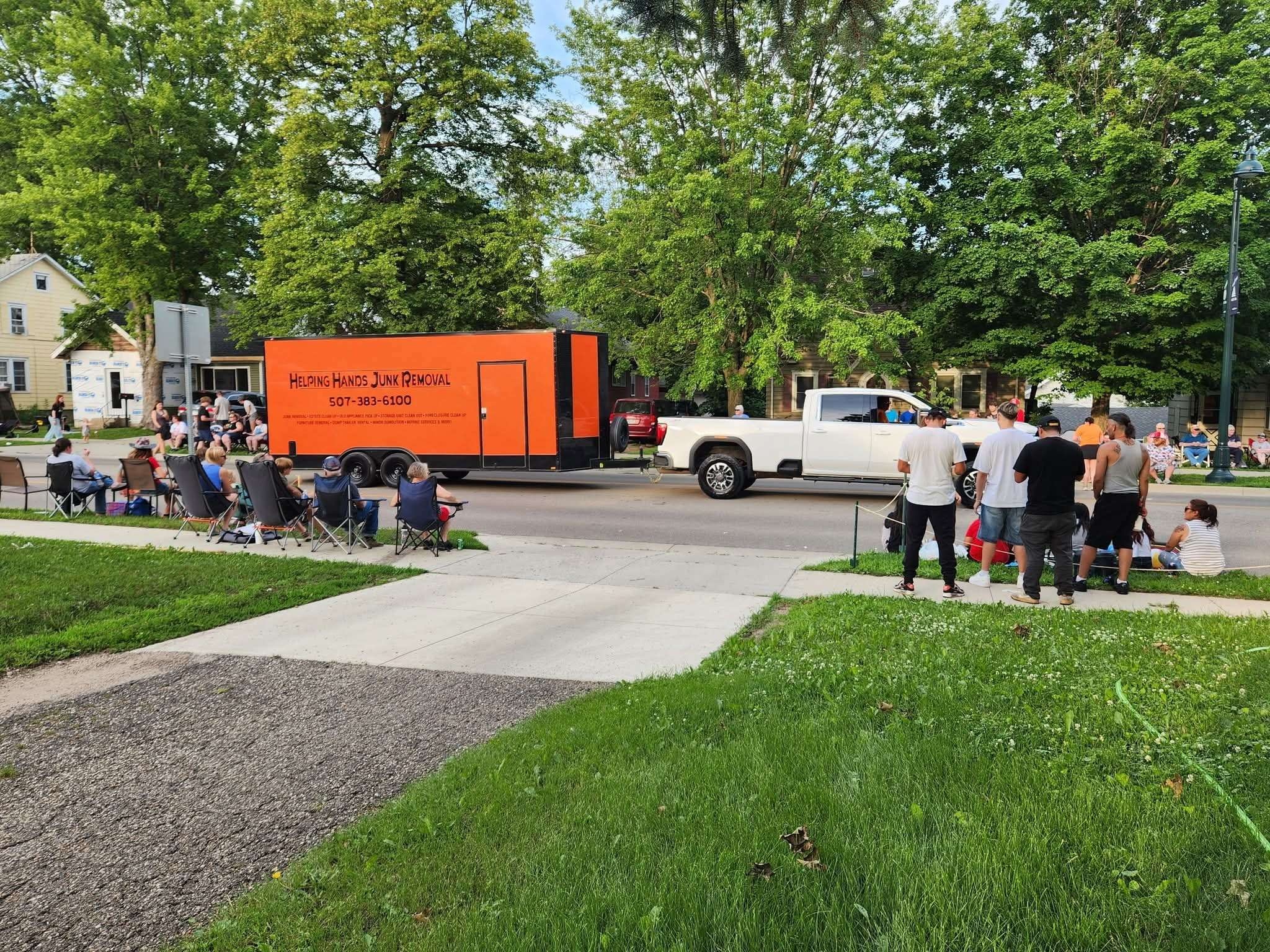 Helping Hands Junk Removal truck and trailer in the community