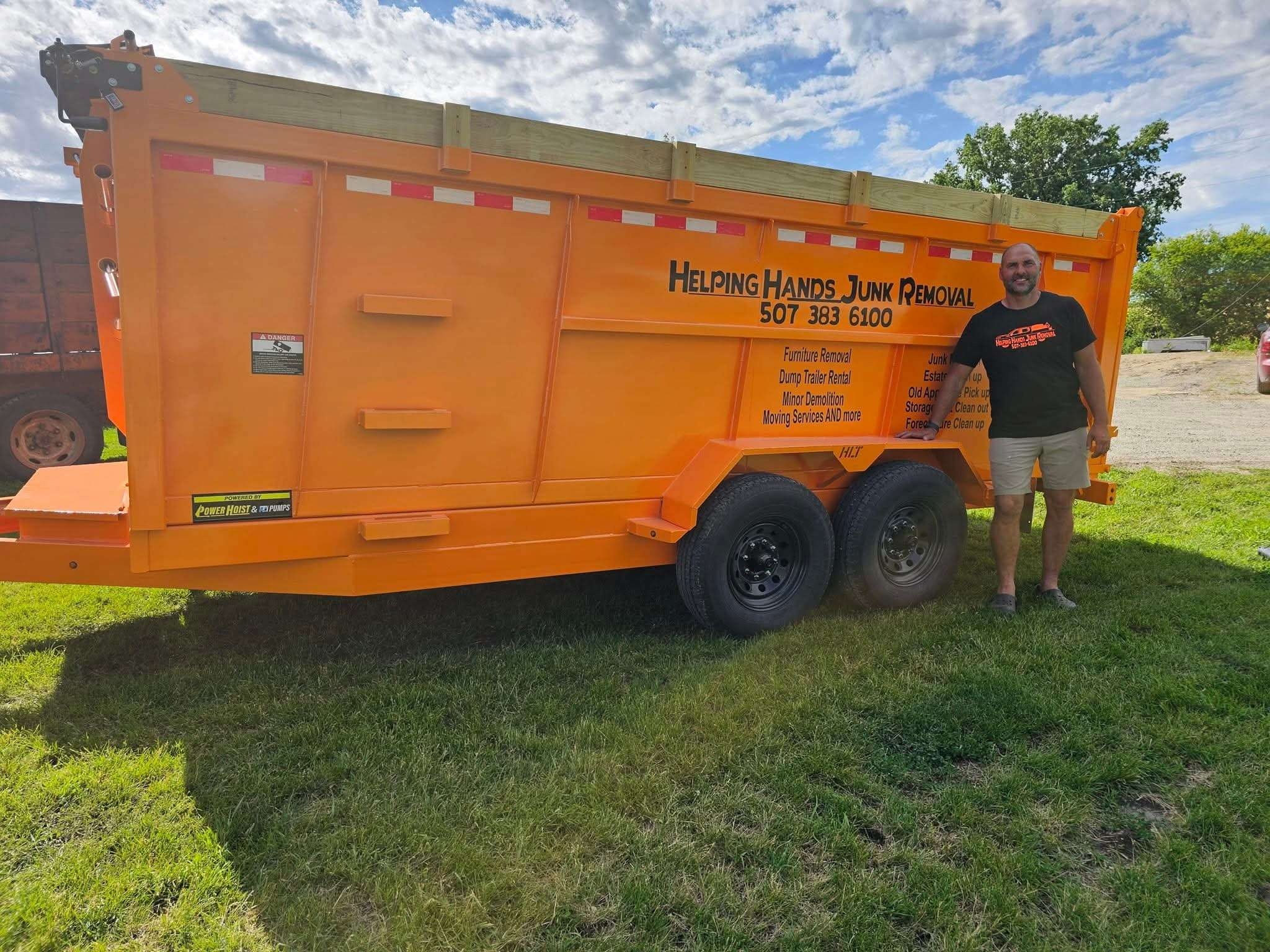 Helping Hands Junk Removal orange dump trailer with Mark